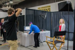 UWO student Mathew Schulz takes professional headshots for students at the Career Fair on Tuesday Sept. 29 at Kolf Sports Center.
