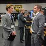 UWO student Michael Mergener speaks with Ryan Passaglia from Krueger International about future job opportunities in marketing.