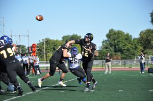 Oshkosh quarterback Brett Kasper targets a receiver in the Titans’ Sept. 19 game against North Park University. Kasper threw for 266 yards and three touchdowns in the 35-0 victory.