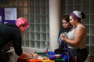 UW Oshkosh Student signs up to learn more more about a club offered at the LGBTQ+ Resource Center