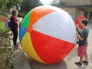 UW Oshkosh students write on a giant beach ball on campus to express their right to free speech. The Young Americans for Liberty inflated and pushed the ball around during the day on Friday in a display of their First Amendment rights.