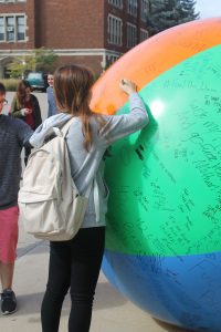 UW Oshkosh students use permanent marker to write messages of their choice on a massive beach ball. The Young Americans for Liberty’s First Amendment event took place largely in front of Polk Library.