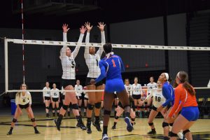 No. 5 Lexi Thiel and No. 1 Nerissa Vogt go up for a double block against the Pioneers on Wednesday night. Vogt recorded a total of three block assists and Thiel had two.