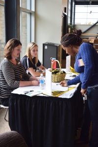 "UW Oshkosh student Afusat Deng signs in at the Almost Alumni lunch and Commencement Open House with Theresa Braatz and McKinzie Halcola of the Alumni Relations office. The lunch and open house brings together  graduating seniors and members of the UWO Alumni Association Board."