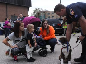 Officer Matt Ziegler shows his dog, Jack, to Allie Ferron and her son, along with Megan Hankwitz. Running With the Cops had multiple service dogs along with horses the attendees could interact with. 