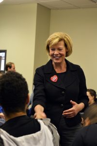 Tammy Baldwin shakes a student’s hand in Reeve Memorial Union. Baldwin visited the College Democrats on Thursday.