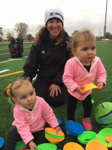 Chloe (left) and Kendall (right) play with women’s soccer head coach Erin Coppernoll.
