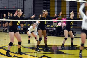 No. 11 Samantha Jaeke, No. 1 Nerissa Vogt and No. 13 Shannon Herman get ready for the serve from Stevens Point. 