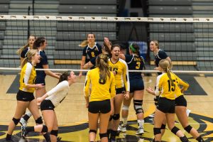 The Titans celebrate after a Carly Lemke kill vs. UWEC. Lemke led the match with 12 kills and a .478 kill percentage. 