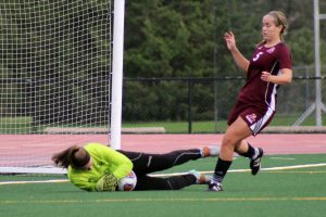 Freshman goalkeeper Madd Runyan saves a shot to stop the Eagles. Runyan made 12 saves during the game.