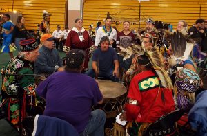 Dancers at the Pow-Wow gather around the Smokeytown drum circle as part of the Grand Entry ceremony.