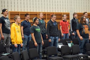 Mens’s choir group practices together.