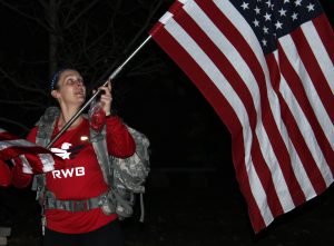 A March For 22 participant displays the American flag during the 2.2 mile walk that started at Dempsey and went through campus.