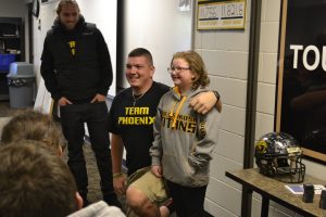 Phoenix attends practice with Brett Kasper. Phoenix and Kasper share a bond together after the bone marrow donation.