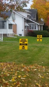 There are rental signs on Elmwood Avenue. The signs are a response to a city ordinance requiring housing inspections.