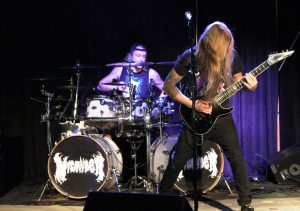 Tyler Lachowicz (drums, left) and Leighton Thompson (guitar, right) of Green Bay metal band, MICAWBER, perform at Metal Night in the Titan Underground Thursday night. 