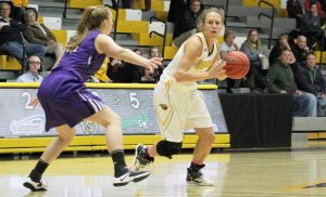 Forward Eliza Campbell drives against UW-Whitewater. The Titans won 59-58 and secured WIAC Championship.