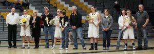 The four Titan players, with their families, being honored on Senior Night (from left): forward Madeline Staples, guard Morgan Kokta, forward Alex Richard and guard Taylor Schmidt.