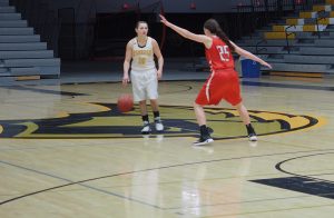 Guard Taylor Schmidt takes the ball across half court during the game on Saturday. Schmidt played 22 minutes.