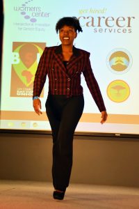 Alexis Palmer walks down the runway Friday in a red-and-black-checkered blazer detailed with gold buttons.