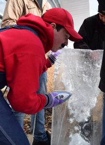 “Mario” from team Gamma Pi Beta, Delta Chi and Theta Chi heats up the ice with an iron to smooth out the Mario-themed sculpture.
