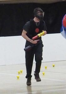 UWO student Brice Vollmer runs across the gym to find the next individual to hit.