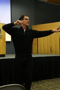 Fitness expert Tom Ryan describes the physical reaction that occurs when people see food that they really want at Tuesday night’s Speaker Series event.