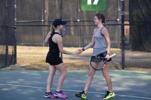 Freshman Lesley Kutnink and sophomore Ashley Polena celebrate winning a match while in South Carolina.