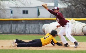 Sophomore outfielder No. 2 Dylan Ott slides back to first base to avoid the tag against La Crosse. The Titans split four games with the Eagles at home.