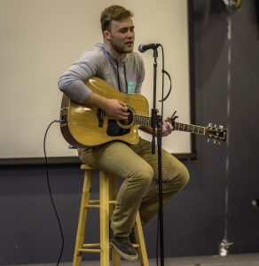 AJ Zemke sings an original song for the talent portion of the Mr. UWO competition in the Reeve Ballroom.