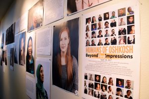 Photographs of Humans of Oshkosh’s Beyond First Impressions exhibit are displayed in the Steinhilber Art Gallery.