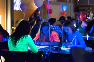 Katelyn Lipson, Brooke Lemkuil and Cortney Kallenberger play bingo during the Bye Gosh Fest announcement party on Thursday in the Titan Underground.