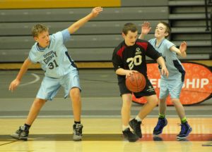 The Door County players defend and block their opponent from shooting a basket on Saturday.