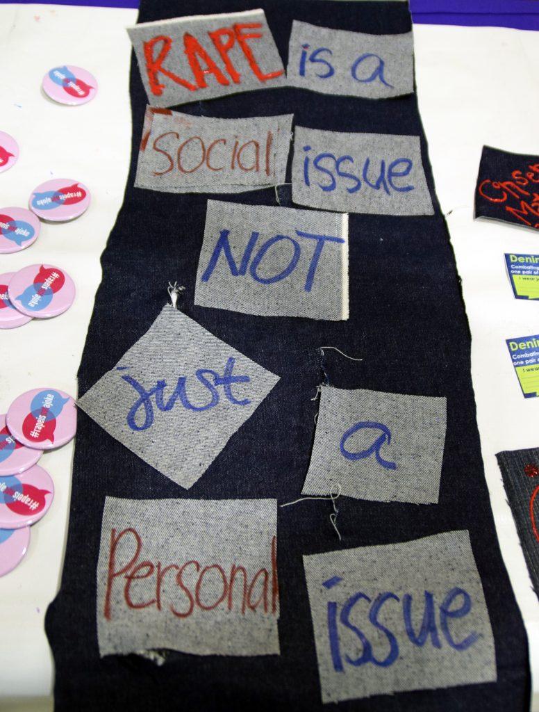 Denim is decorated with a quote for sexual assault awareness. Denim, a symbol to raise awareness of sexual assault, is hung up during the presentation for Denim Day.