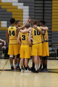 The men’s D-I volleyball team huddles after a match