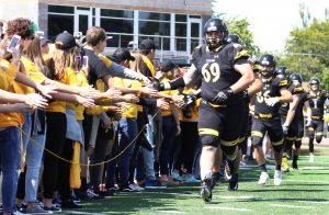 UWO freshman and new students take part in Titan Takeover, cheering on the Football team running onto the field.