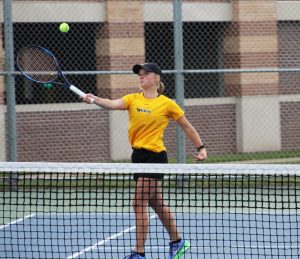 UWO sophomore Lesley Kutnink charges the net to return a ball during a home match.