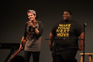 2017 UWO Homecoming talent show host Aza Muzorewa leads contestant Demetra Prochaska off stage following the act. The event showcased many student performers, illustrating the extreme diversity of talent among students across campus.