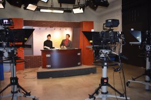 Titan TV news anchors Sasa Miladinovic and Tyler Cox prepare for their broadcast. Titan TV news is produced every Friday at 4 p.m. and will also be making the transition to HD along with the rest of the channel.