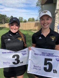 Micayla Richards (left) and Kayla Priebe hold flags from the Stevens Point Country Club after placing in third and fifth places, respectively.