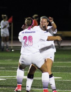 Abby Austin (No. 28) and Maddie Morris (No. 26) celebrate a goal scored by Morris.