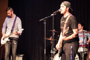 A Battle of the Bands contestant sings while also toting lead guitar duties. Seven bands participated in the competition this year, over half being new acts.
