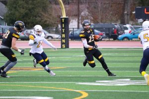 UW Oshkosh junior wide receiver Dom Todarello runs from a Lakeland defender in the WIAC playoffs.