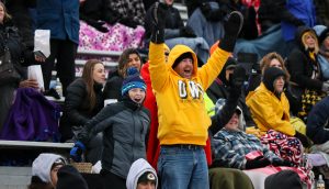 UW Oshkosh fans leap with excitement during the Titans second round playoff matchup against North Central College (Ill.)