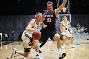 Ben Boots drives against a Benedictine player to open the season on Nov. 15. In the game, Boots had 22 points on 12 shots.For the game, Kasper tied a career high with four touchdowns.