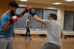 Junior Nicholas Metoxen (left) and senior Alex Horkman (right) get warmed up for Boxing Club. The Boxing Club has updated it’s marketing to promote the club as a workout club rather than a fighting club.