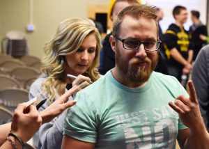 Sarah Swafford autographs the shirt of a UW Oshkosh student after the event.