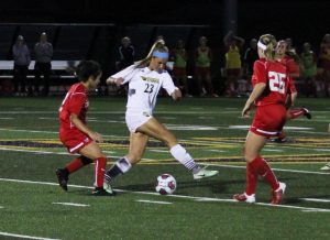 UW Oshkosh freshman forward Delaney Karl dribbles the ball through the opposing defenders at J.J. Keller Field this year.