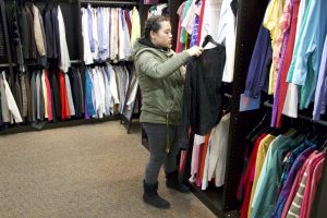 Students picks out free clothing items available at Career Services.
