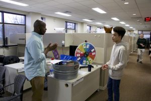 Service Engagement Assistant Bryan Carter speaks with student.